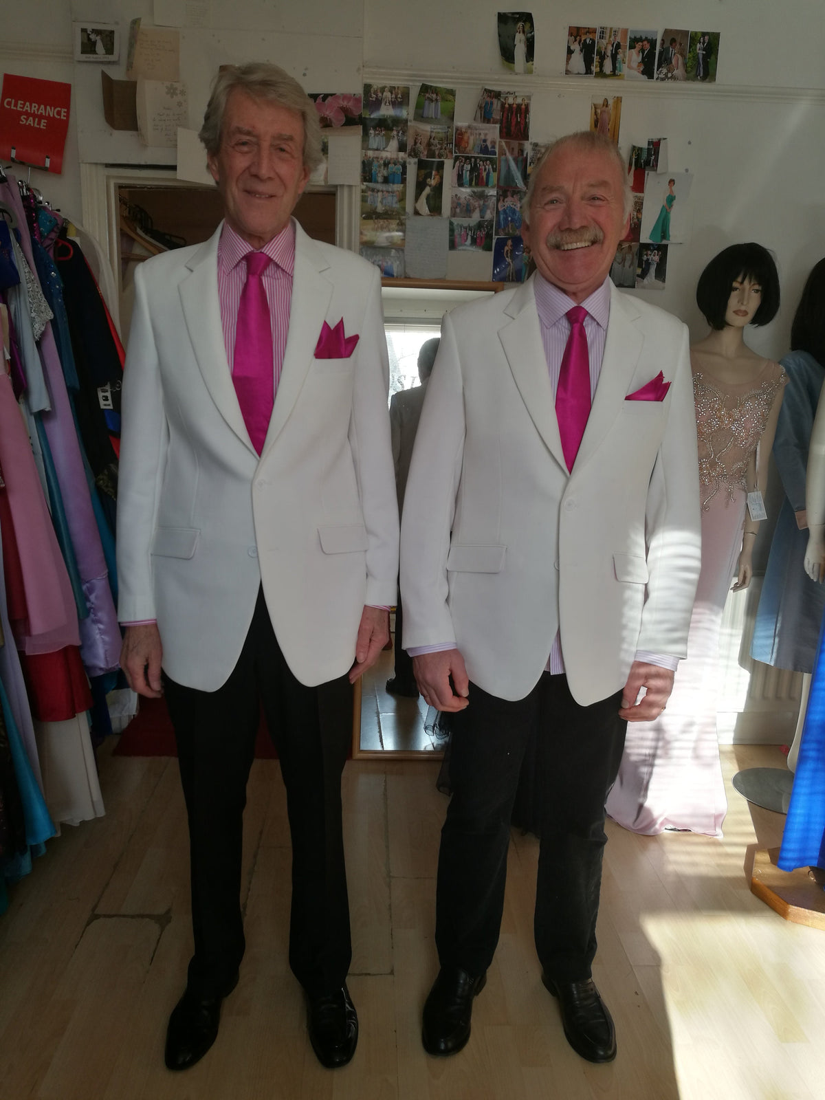 Two grooms in matching ivory wedding jackets with fuchsia ties – bespoke same-sex wedding suits by XCLUSIV, Horsham