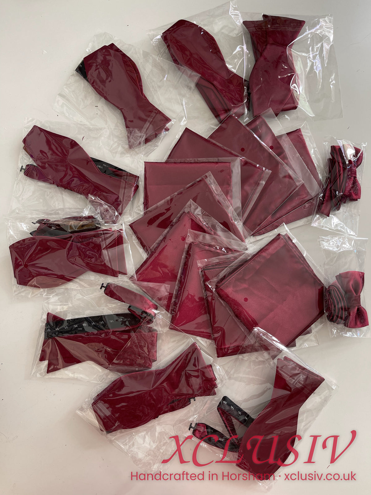 Burgundy satin bow ties and pocket squares packed for a wedding party – XCLUSIV Horsham