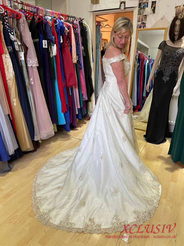 Ivory Satin Off-Shoulder A-Line Wedding Dress with Gold Embroidery – XCLUSIV Horsham (view 4)